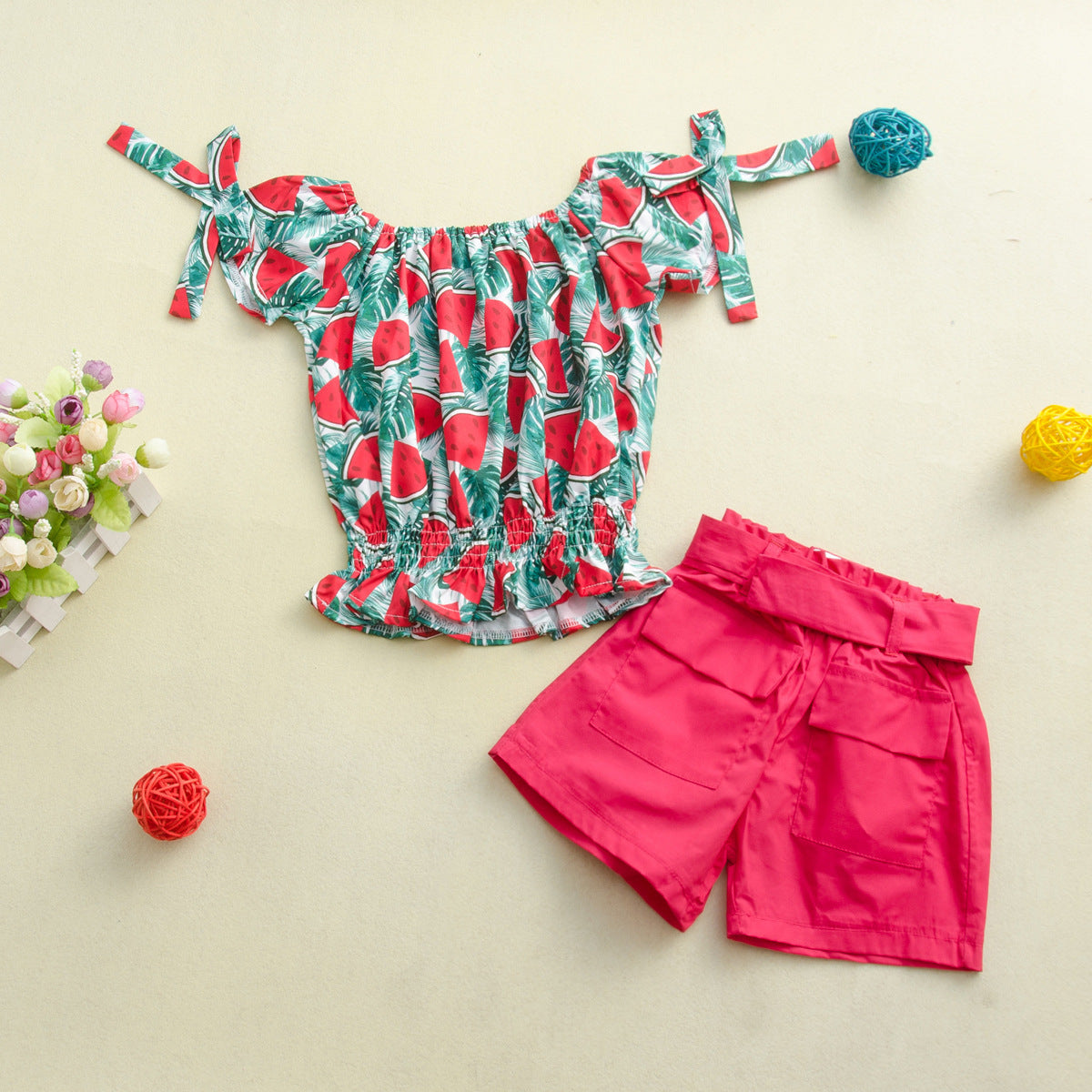 Two-piece children's suit with solid color shorts