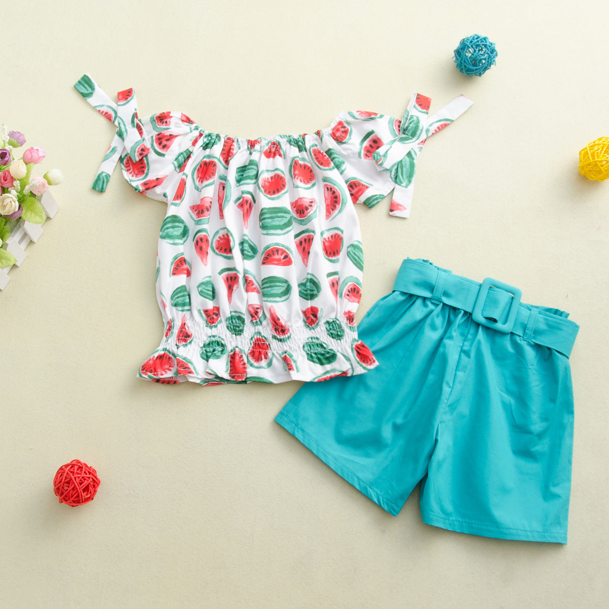 Two-piece children's suit with solid color shorts